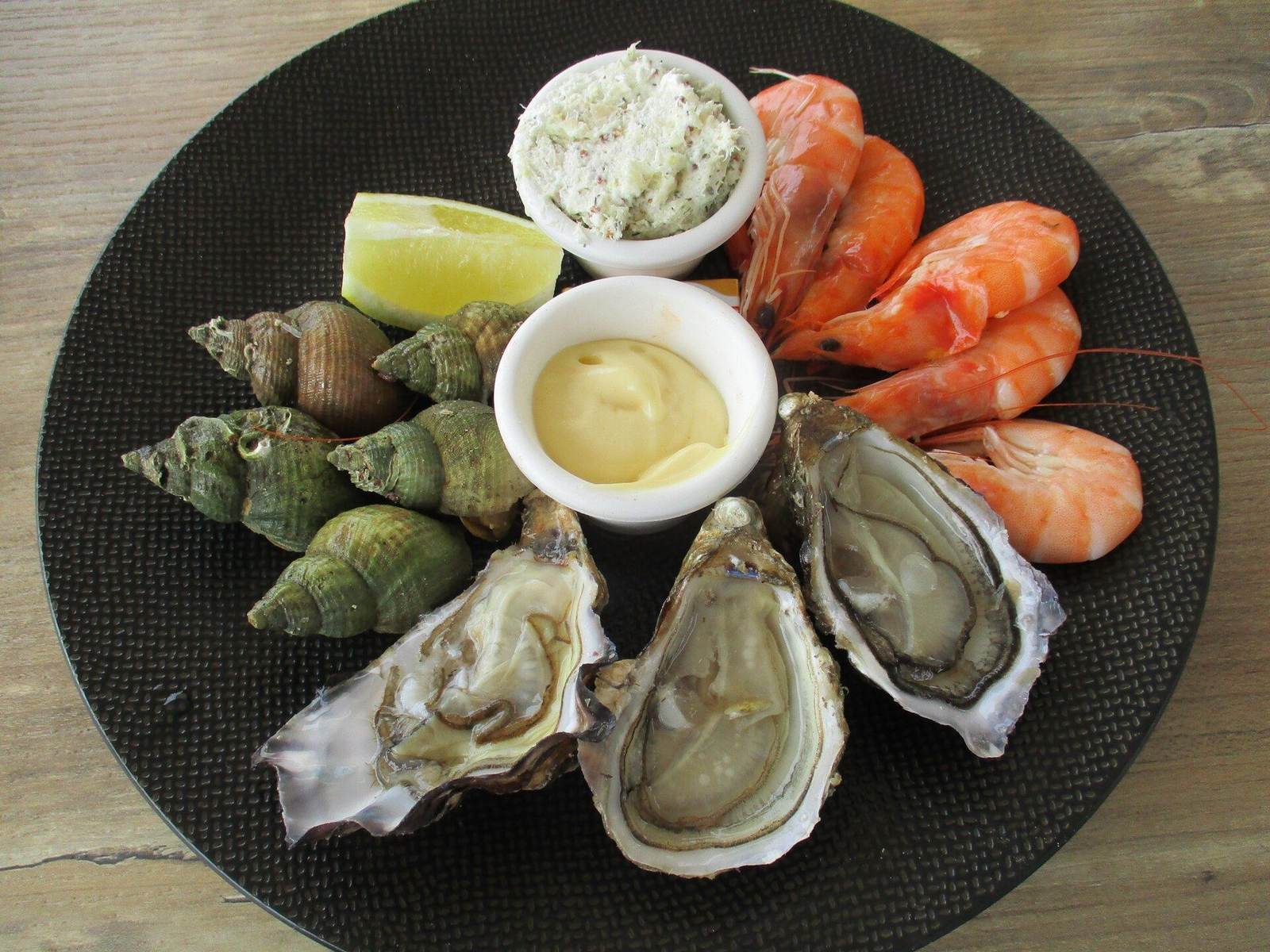 Seafood platter with oysters and crab on a marble table