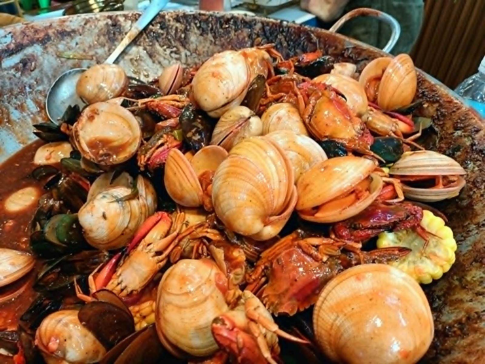 Seafood platter with oysters, crab, and langoustines on ice